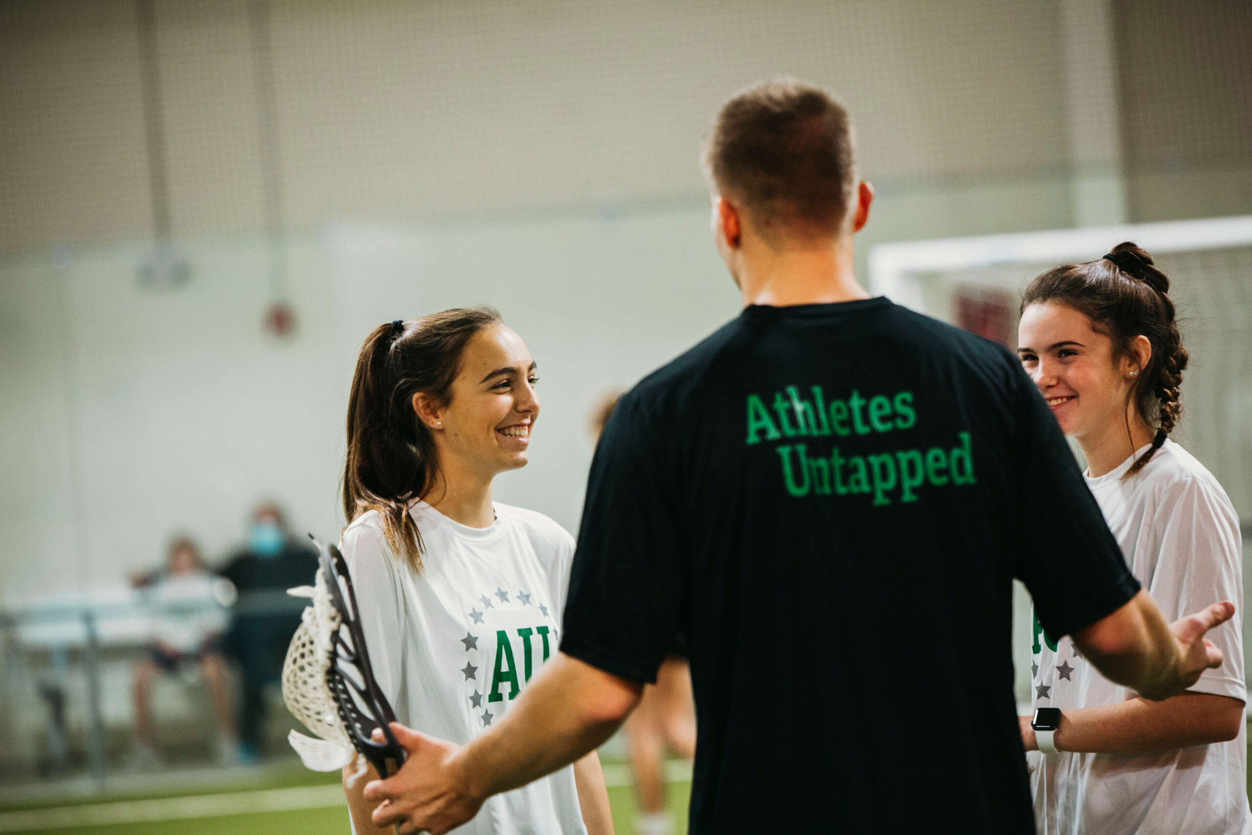 Private lacrosse coach teaching a young athlete during lesson