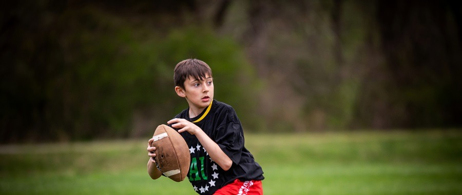 Young athlete training during a private football lesson