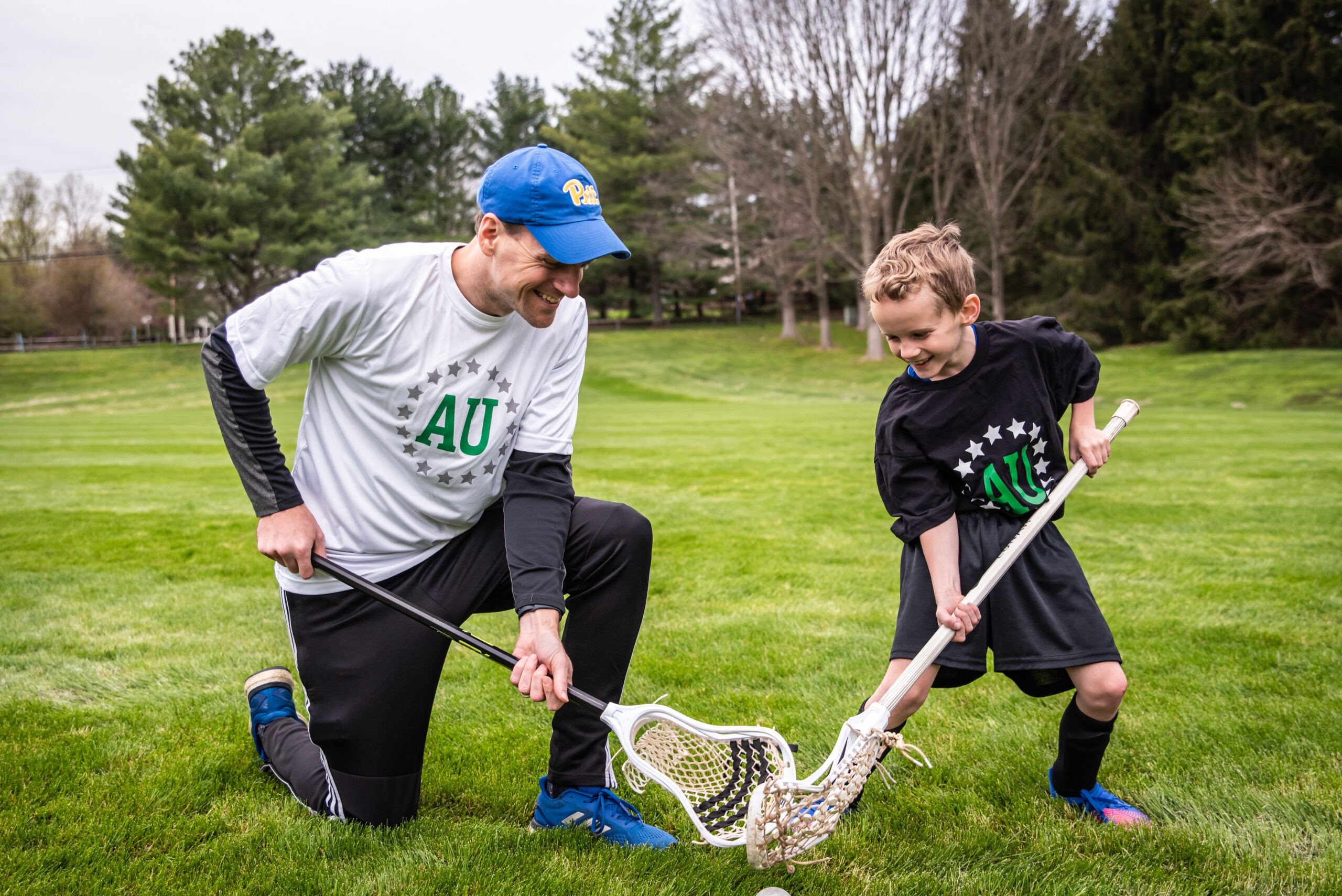 Private lacrosse coach teaching a young athlete during lesson