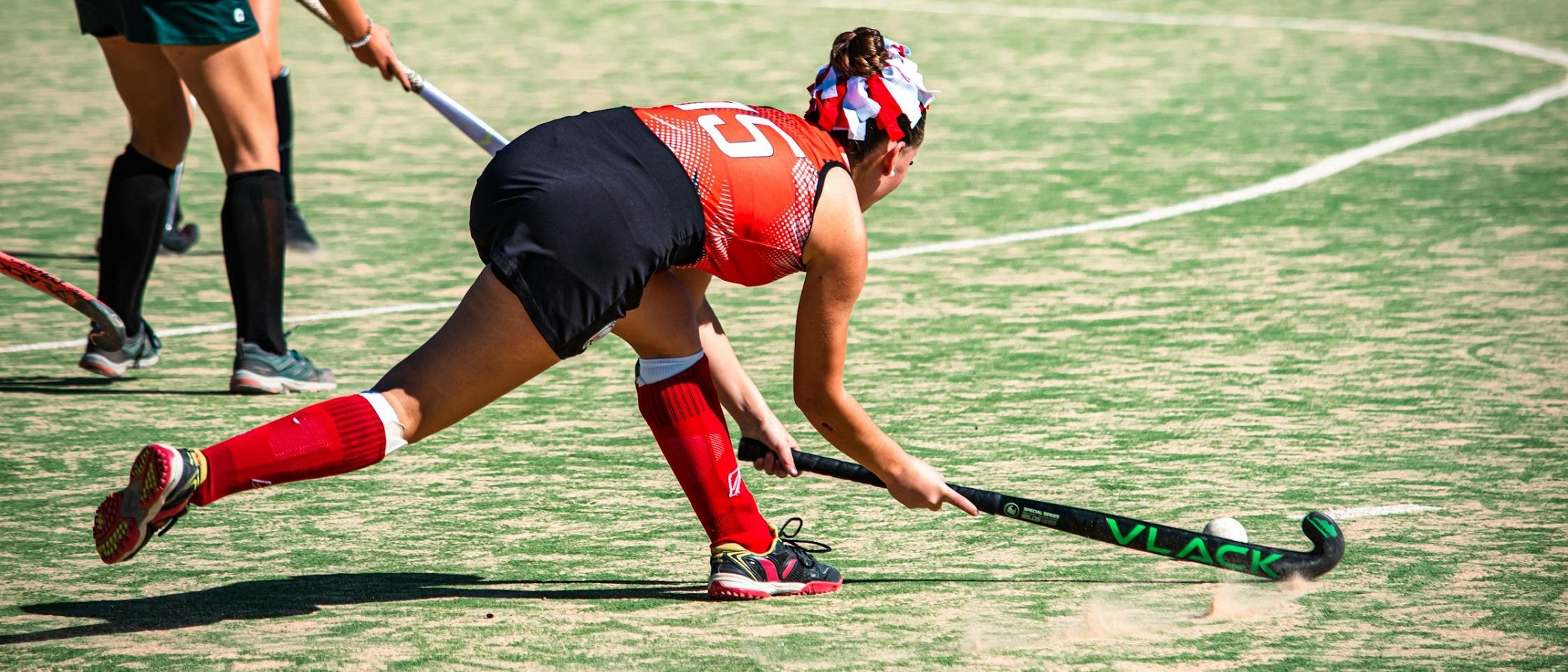 Field hockey player taking a swing during a private lesson