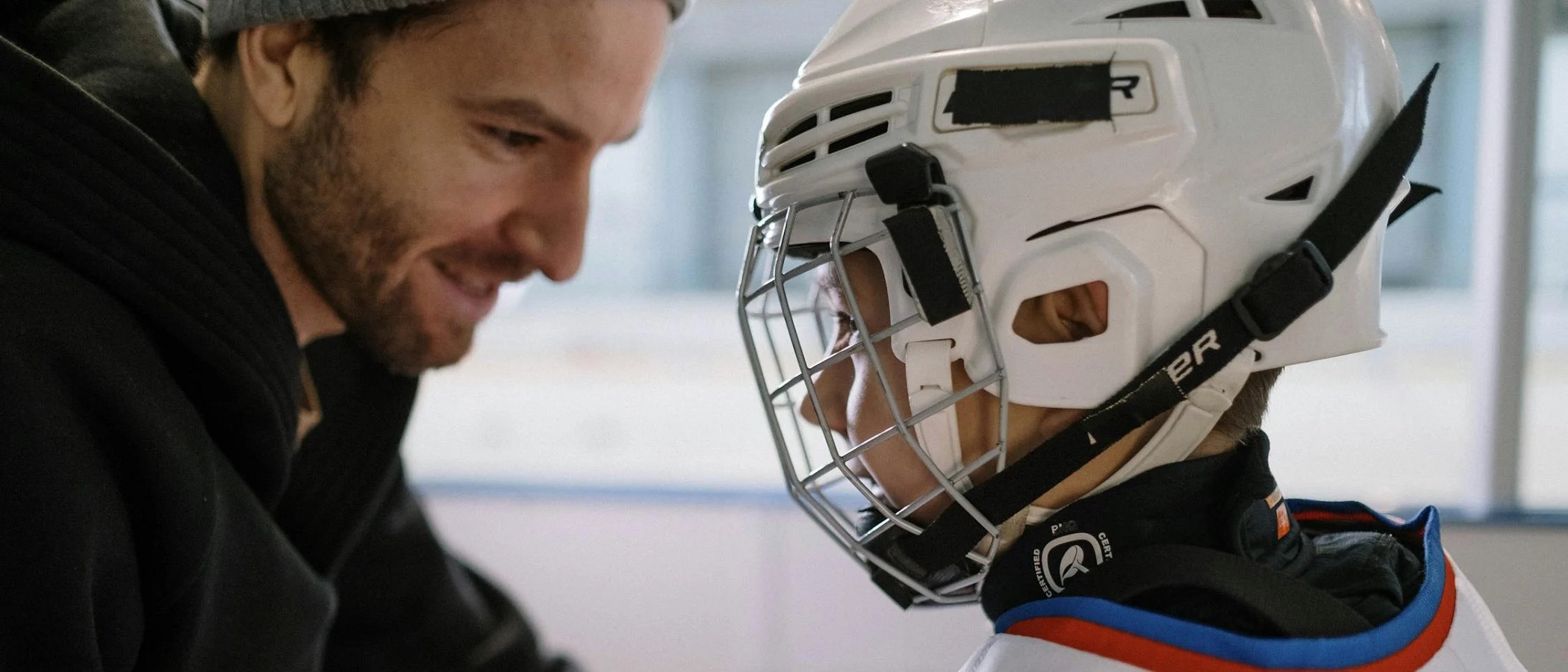 Private ice hockey coach teaching young athlete during lesson